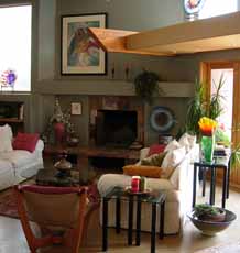 Living area with fireplace of a poured earth home